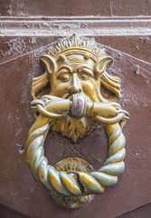 Iron medieval doorknob in the shape of  devil's head