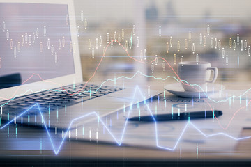 Forex graph hologram on table with computer background. Double exposure. Concept of financial markets.