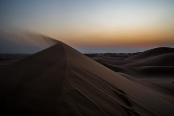 Fototapeta na wymiar Dunes red desert abu dhabi dubai sunset sundown 