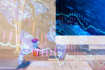 Forex market graph hologram and personal computer on background. Double exposure. Concept of investment.