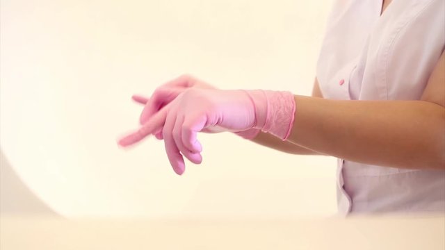The doctor puts rubber gloves on his hand. the medic is preparing for surgery. Concept of medicine, medical instruments, healthcare. Isolated, copy space