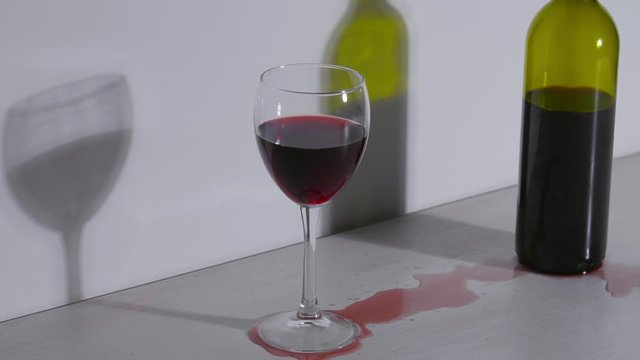 Conceptual shot, a bottle of wine and a glass on a white background