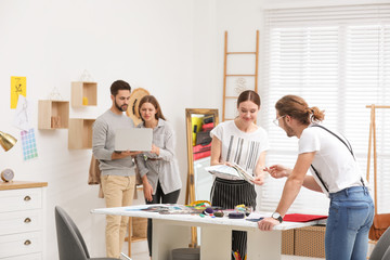 Fashion designers creating new clothes in studio