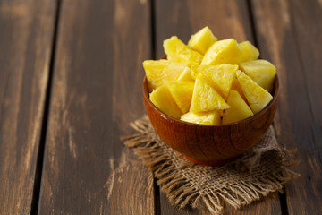 fresh pineapple pieces on wooden surface