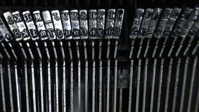 Typo keys of a qwerty typewriter hitting the text
