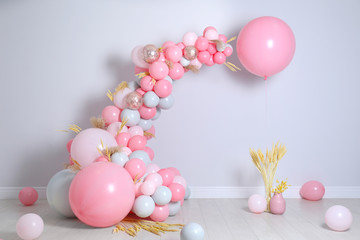 Beautiful composition with balloons and spikelets near light wall