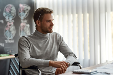 Thoughtful architect. Portrait of handsome and confident male office worker with a pencil behind...