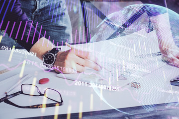 Financial trading chart double exposure with man desktop background.