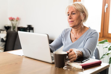 Adult woman checking email on the laptop