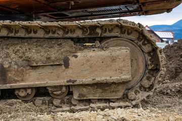 Fototapeta na wymiar Tracks of a excavator machine on a construction site.