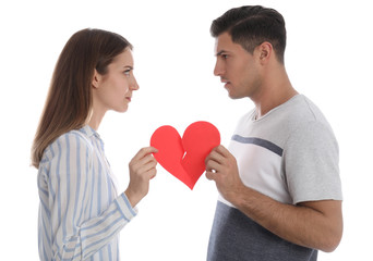 Fototapeta na wymiar Couple tearing paper heart on white background. Relationship problems