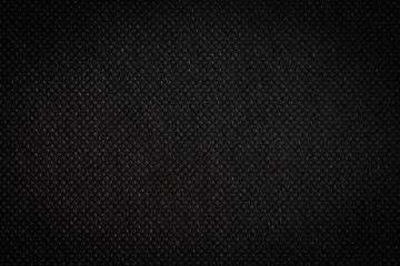 Black fabric, luxury dark gray background abstract. Material are used in textile assembly. Detail cloth texture of pattern. Design, elegance with vignette effect, free copy space for text placement.