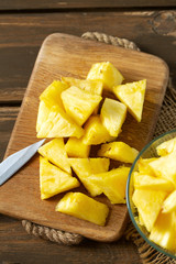 fresh pineapple pieces on wooden surface
