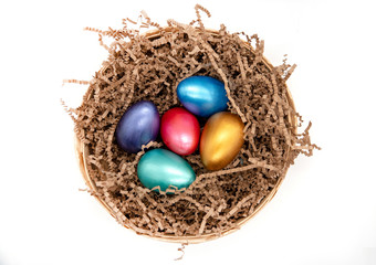 Fototapeta na wymiar color easter eggs in basket isolated on white