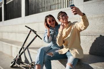 Catching the moment. Friends riding electric scooter on a sunny day © Svitlana