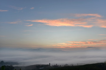 Beutiful sea of fog in a valley with orange sky cloud in a sunrise time