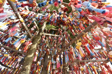 Hanging colorful heart like mobile on bamboo rail