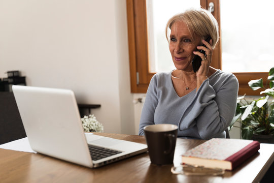 Adult Woman Talking To The Phon Smart Working