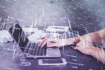 Double exposure of forex chart with man working on computer on background. Concept of market analysis.