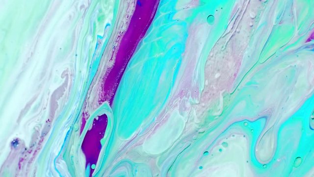 Abstract psychedelic background. Multicolored paints slowly pour into patterns in milk