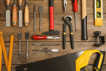 Flat lay composition with carpenter's tools on wooden background