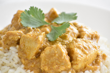 Chicken Korma on a white plate. Soft and selective focus. Traditional Indian food. 
