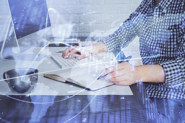 Double exposure of stock market chart with man working on computer on background. Concept of financial analysis.