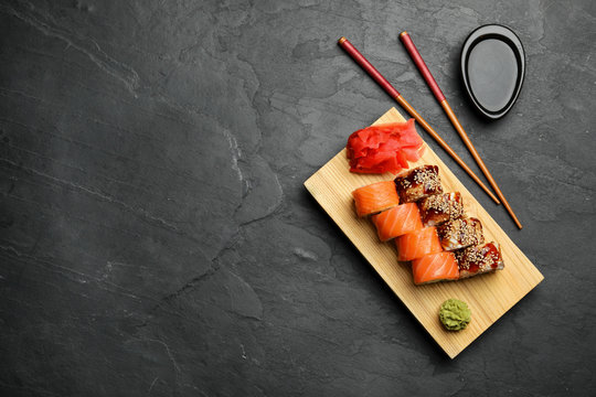 Delicious Sushi Rolls On Dark Grey Table, Flat Lay. Space For Text