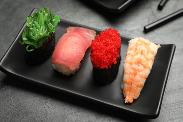 Set of delicious sushi on grey table