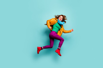 Fototapeta na wymiar Full length profile photo of funny fast lady jump high rush sale shopping center wear casual yellow coat scarf magenta pants turtleneck footwear isolated teal color background