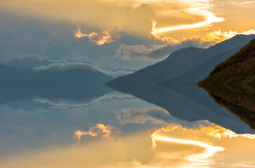 Sunset on a lake with the mountains in the background