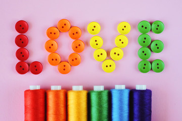 LGBT flag colors creative concept. Rainbow color sewing treads and  word 