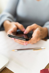 businesswoman typing a message on her mobile phone