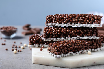 Delicious rice crispy treats on grey table, closeup