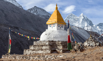 Buddhist Chorten with praying flags on the background of majestic Kangtega peak (6782 m) in Nepal, Himalayas