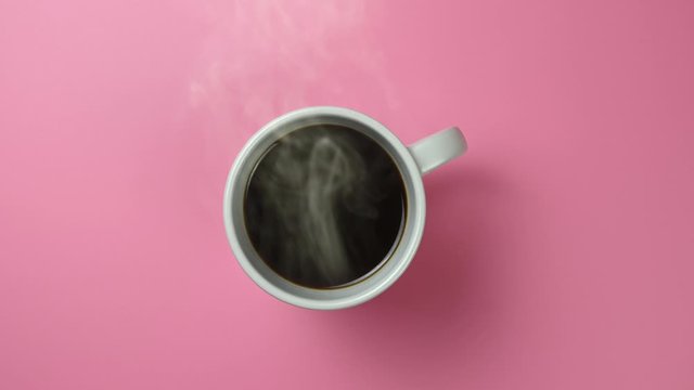 coffee is on table and steam is coming out of mug