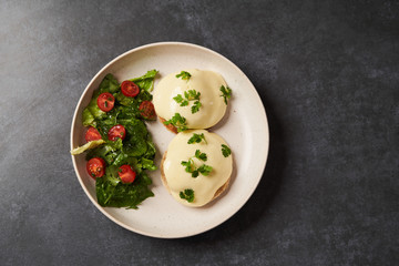 Eggs benedict with bacon meat and fish, close-up