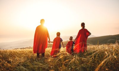 concept of super family, family of superheroes at sunset