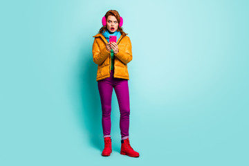 Oh no. Full size photo of traveler lady hold telephone open mouth read bad news wear trendy casual yellow overcoat scarf purple pants shoes isolated teal color background