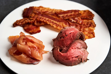 Eggs benedict with bacon meat and fish, close-up