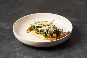 Baked eggplant with Grated cheese and herbs, close-up