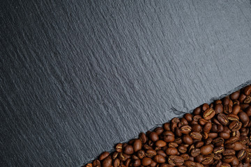 Coffee beans next to the slate board. Top view. Copy space.