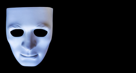 White color plastic face mask isolated on a black background for drama, Halloween style.