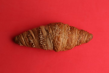 delicious spelled croissant in color background