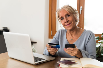 adult woman buying on the smartphone with credit card