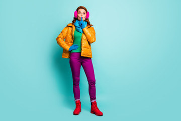 Hush secret. Full length photo amazed woman dont share private information put index finger mouth wear yellow boots purple pants trousers green jumper isolated teal color background