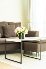 Vase flower on table with pillow and sofa decoration interior