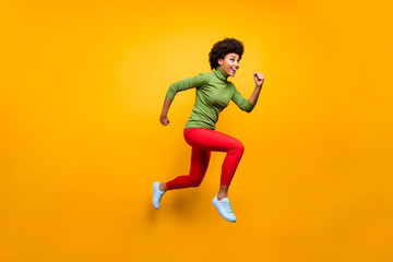 Fototapeta na wymiar Full length body size view of her she nice attractive lovely girlish cheerful cheery wavy-haired girl jumping running activity isolated over bright vivid shine vibrant yellow color background