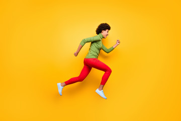Fototapeta na wymiar Full length body size view of her she nice attractive cheerful cheery wavy-haired girl jumping running having fun free time isolated over bright vivid shine vibrant yellow color background