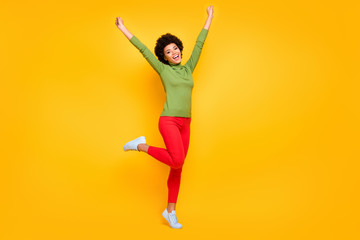 Fototapeta na wymiar Full length body size view of her she nice attractive lovely teenage cheerful wavy-haired girl celebrating having fun free time isolated over bright vivid shine vibrant yellow color background